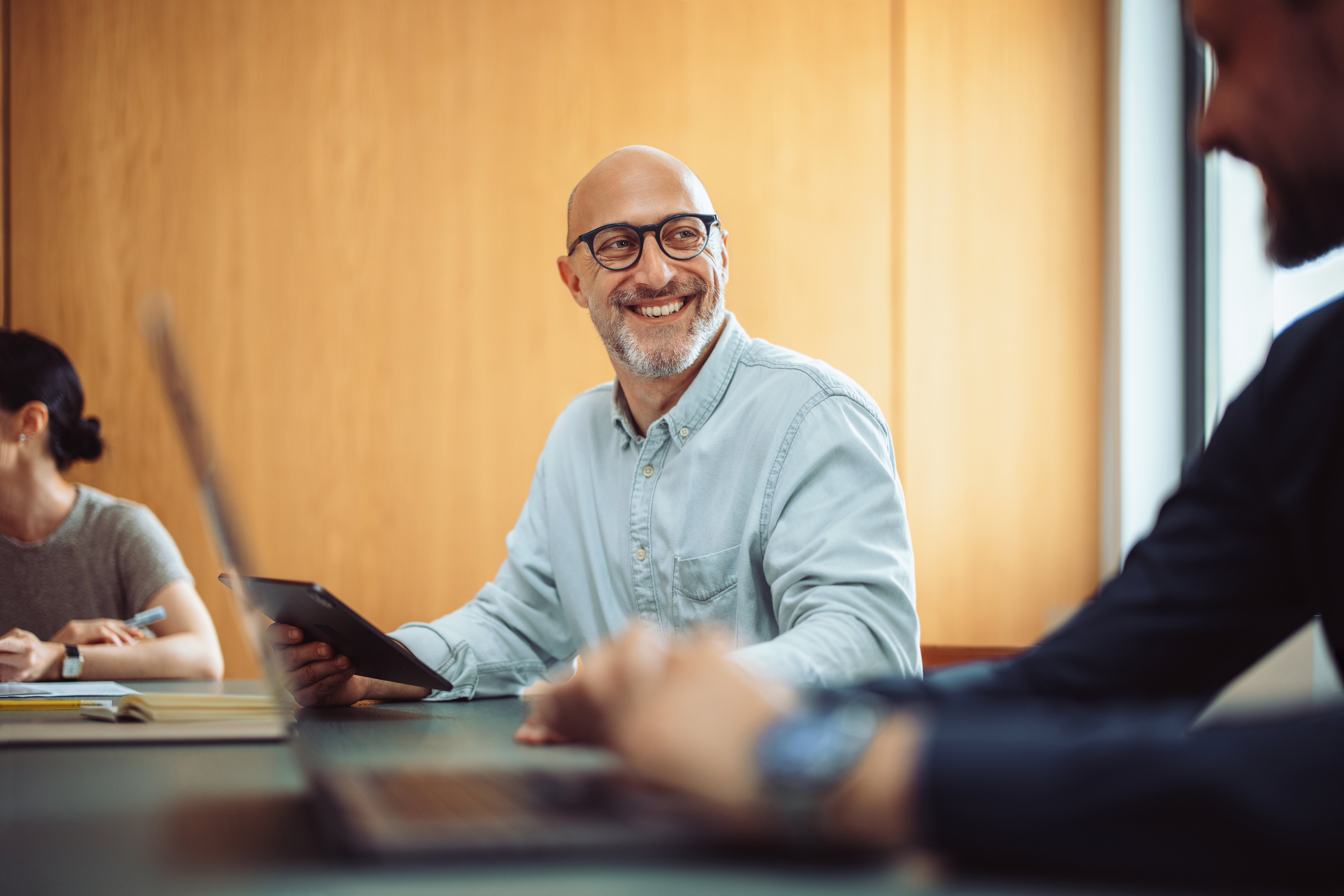 Businessman smiling at someone off camera.