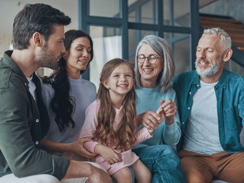 A multigenerational family posing together for a photo.