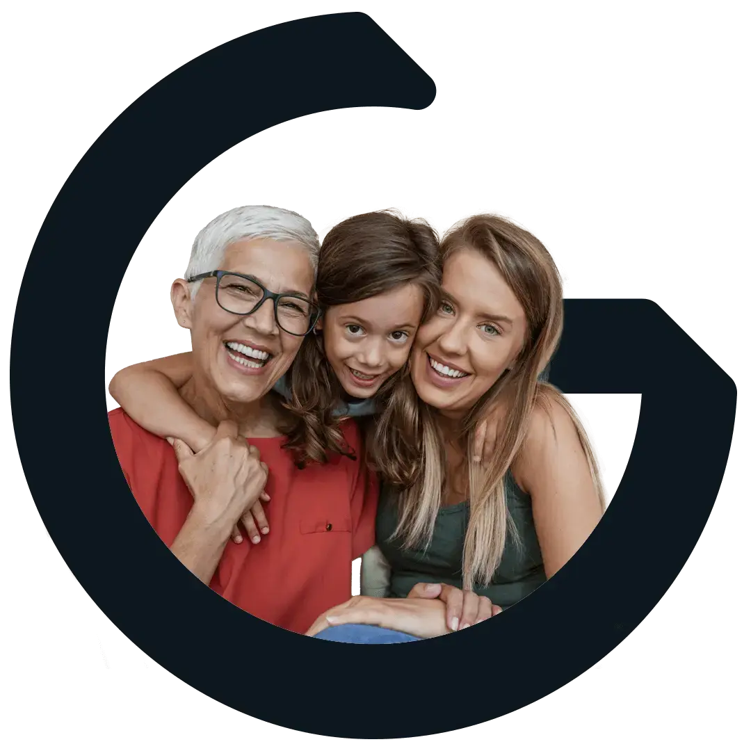 Grandmother, daughter, and granddaughter smiling and looking forward.