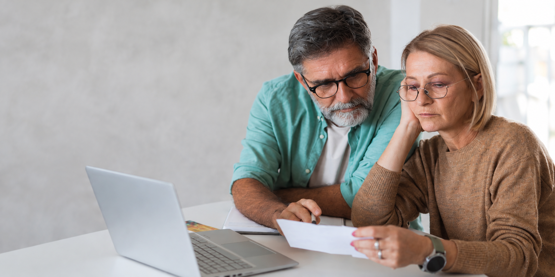 Married husband and wife reviewing retirement plans.